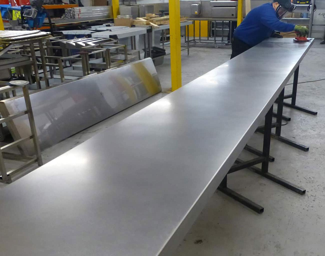 Stainless steel bar top showing distressing process